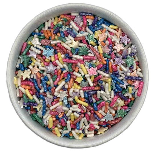 A bowl filled with Rainbow Circus Sprinkle Blend featuring colorful jimmies and star-shaped sprinkles in a variety of metallic shades.