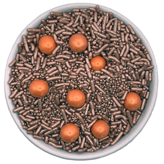 Rose gold sprinkle blend in a 3.2 oz container, featuring a mix of textured sprinkles and shiny rose gold pearls, ideal for upscale dessert decoration.