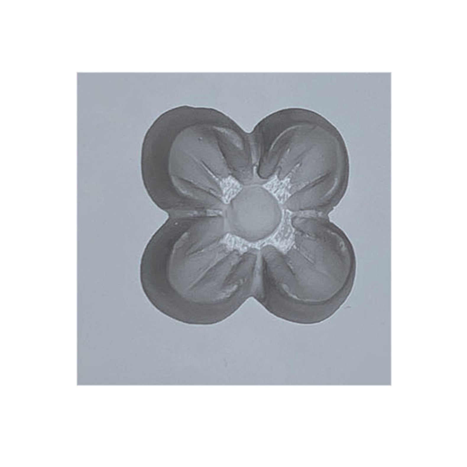 Close-up of a single cavity from the Small Dogwood Flower Rubber Mint Mold, showing a four-petal flower shape ideal for creating dogwood-shaped mints or candies.