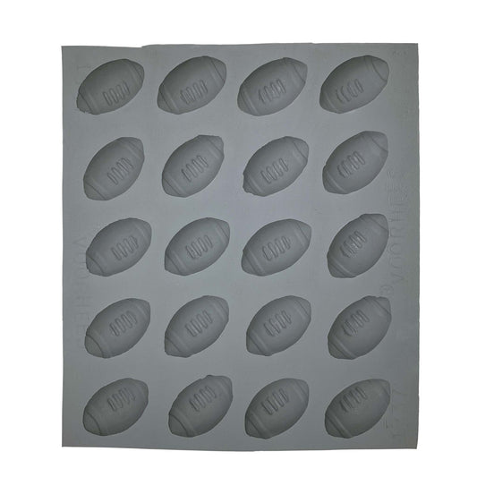 Full sheet of 20 football-shaped cavities in a natural rubber mold used for creating sporty treats for game day or football-themed parties.
