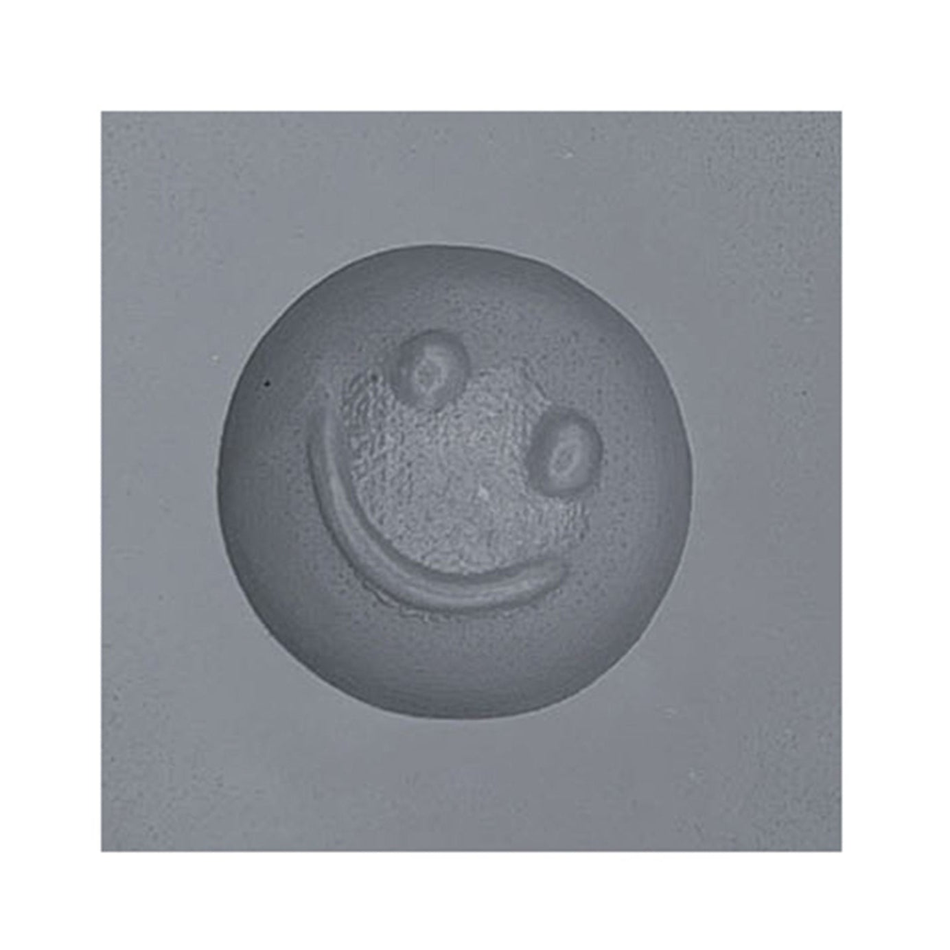 Close-up of smiley face rubber mint mold cavity for cheerful mint or chocolate shapes.