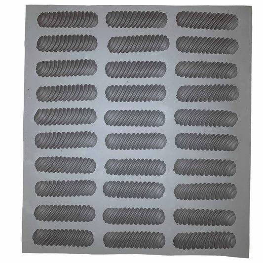 Full sheet of spiral rubber mint molds featuring multiple cavities for making twisted mints, chocolates, or fondant pieces