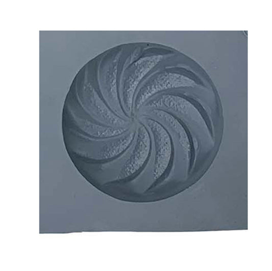 Close-up of swirl rubber mint mold cavity with spiral design for candy making