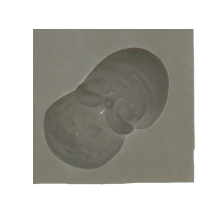 Close-up of Santa face rubber mint mold with detailed features like hat and beard for festive candy making