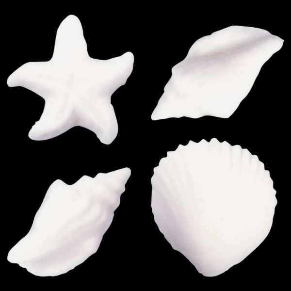 Assorted white sugar decorations shaped like seashells and a starfish, perfect for cake and cupcake decorating.