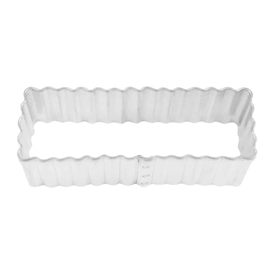 Metal shortbread cookie cutter with a fluted rectangular design, top-down view.