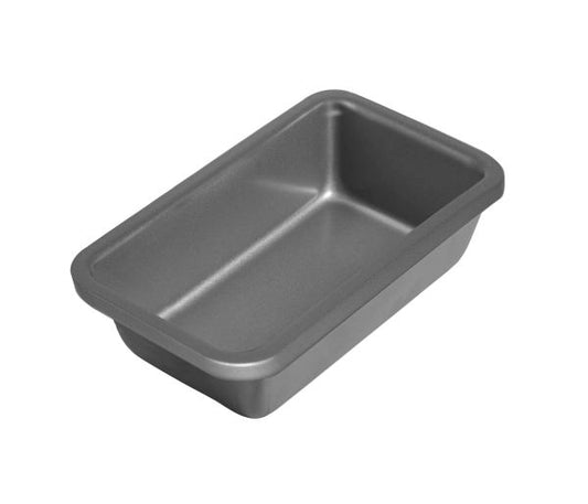 Angled view of the Wilton silver non-stick loaf pan showing straight sides, rounded interior corners, and matte gray finish; compact 8x4 size for breads and cakes.