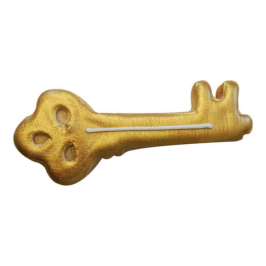Golden skeleton key-shaped cookie decorated with edible gold coloring and white icing detail.