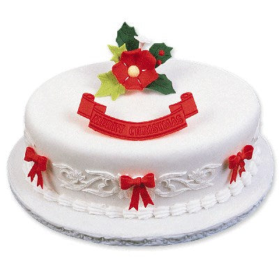 White fondant cake decorated with red bows made from bow cutter set and holiday accents