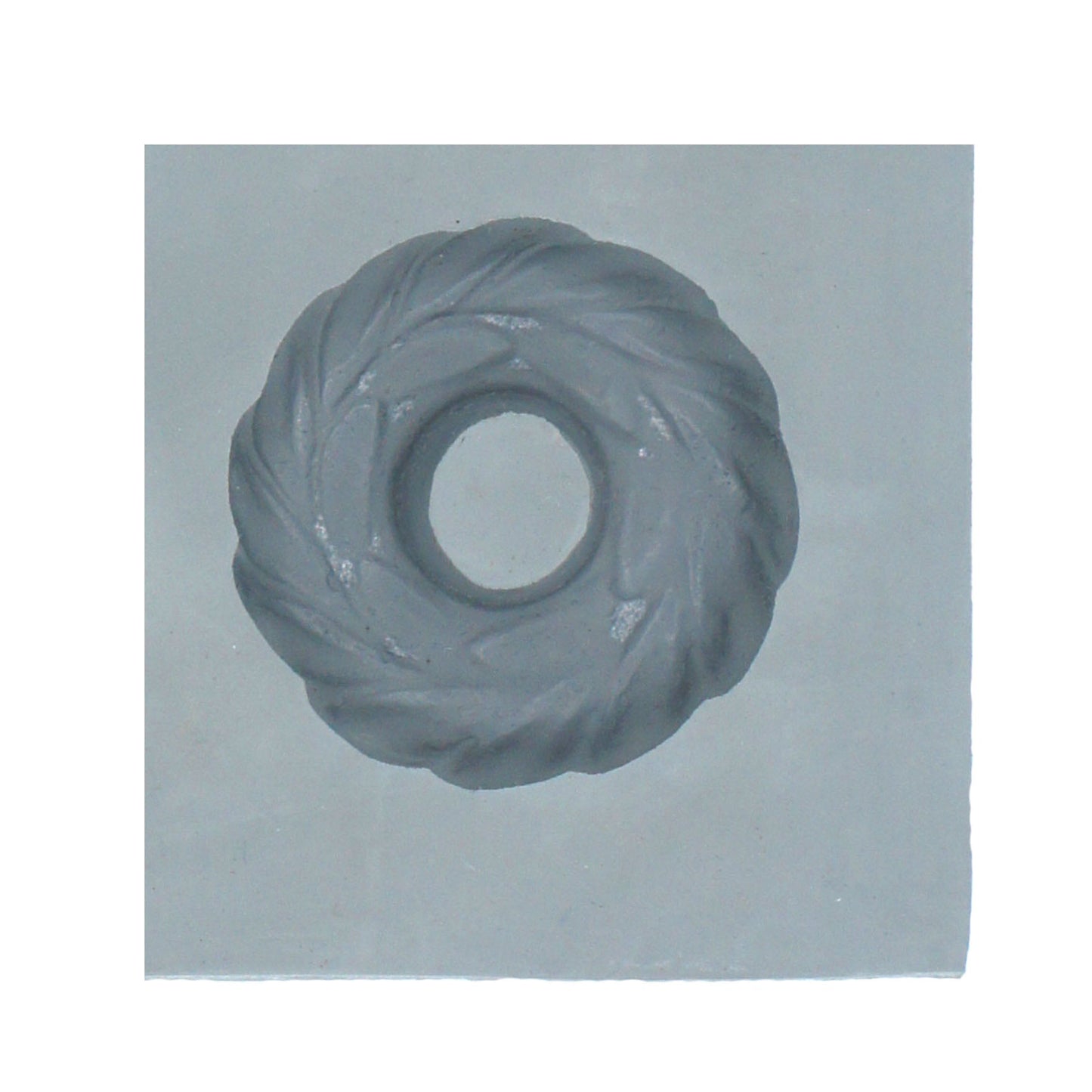 Close-up of small Christmas wreath rubber mint mold featuring twisted evergreen-style detailing