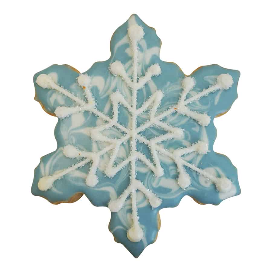 Decorated snowflake-shaped cookie with a marbled blue background and white icing details.
