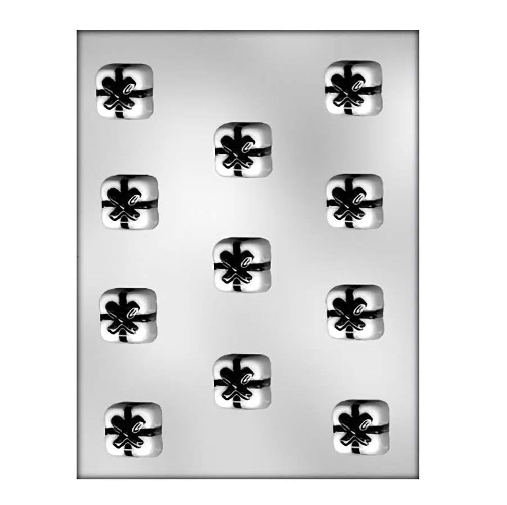 Chocolate mold with nine square cavities, each adorned with a raised bow design, creating the appearance of gift-wrapped packages perfect for party favors or holiday treats.