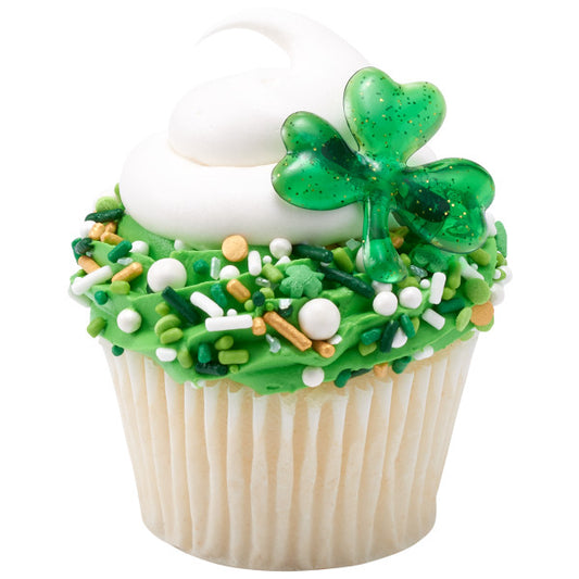 St. Patrick’s Day Fusion Sprinkle Mix featuring a festive blend of green, white, and gold sprinkles, quins, nonpareils, pearls, and sanding sugars, on a cupcake.