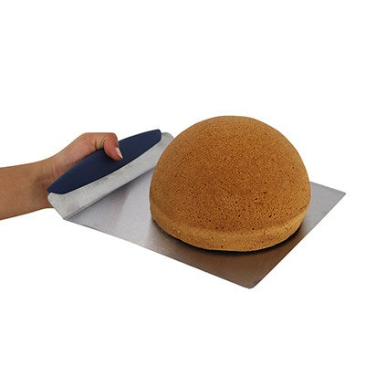 Cake being lifted with PME stainless steel cake lifter tool, showing secure grip and smooth surface support.