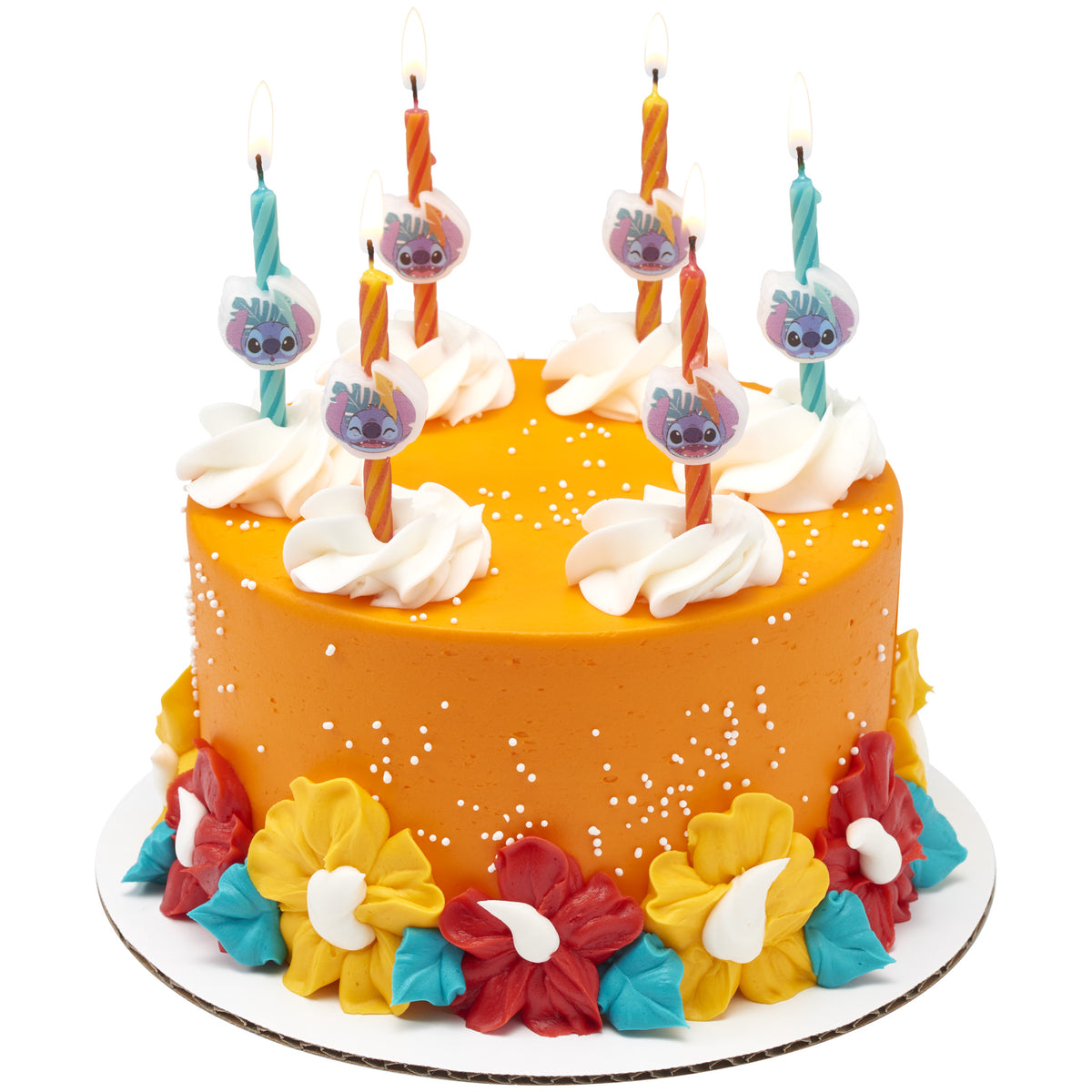 Orange birthday cake with white frosting swirls, tropical red and yellow flowers, turquoise accents, and six lit Stitch birthday candles on top.
