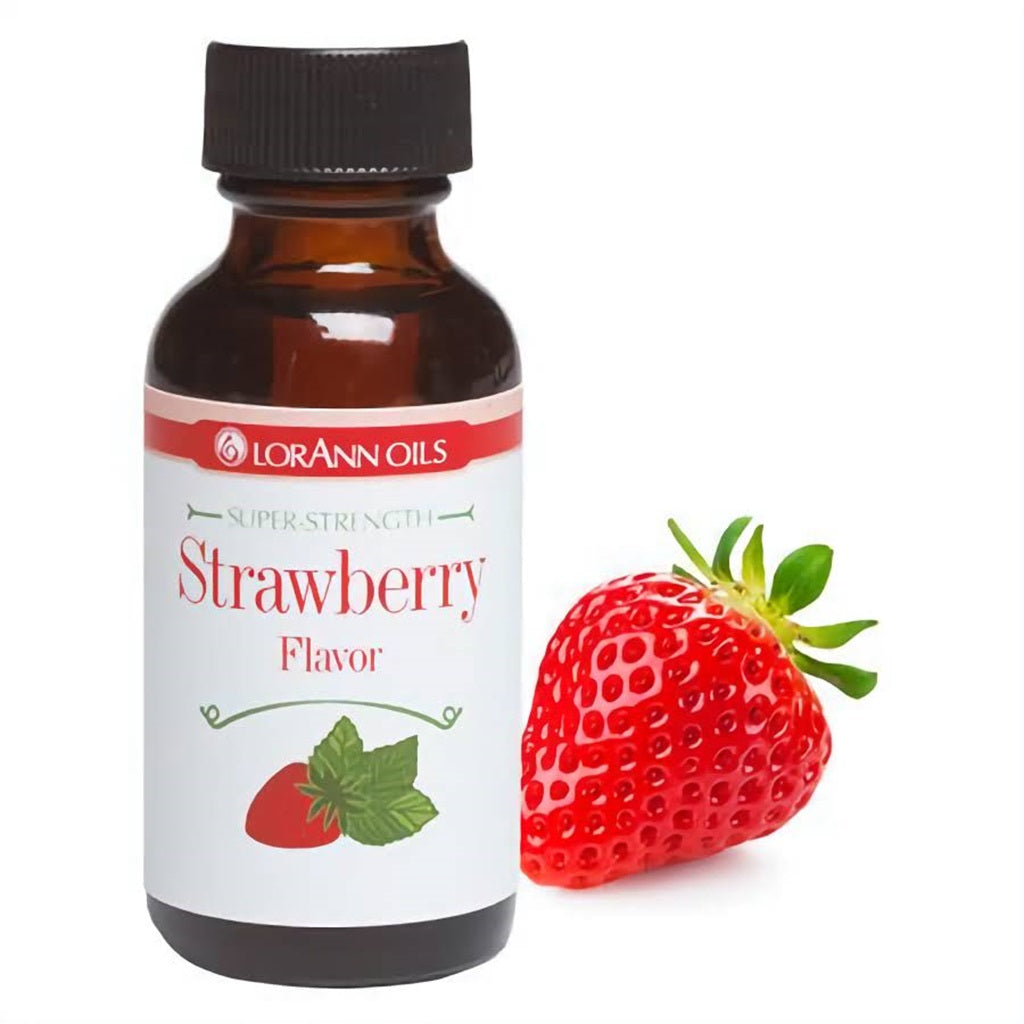 LorAnn Super Strength Strawberry Flavor in a dark bottle alongside a ripe red strawberry, highlighting the concentrated extract for gourmet desserts.