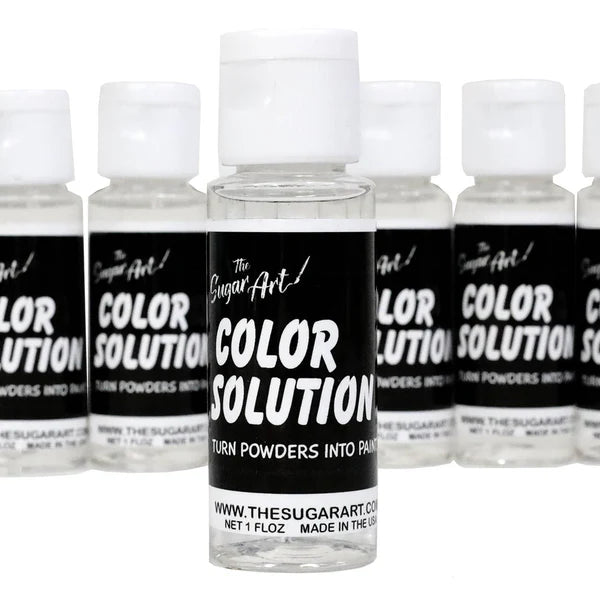 The Sugar Art Color Solution bottles lined up with front label showing; designed to mix with edible powders and luster dusts to create food-safe paint.
