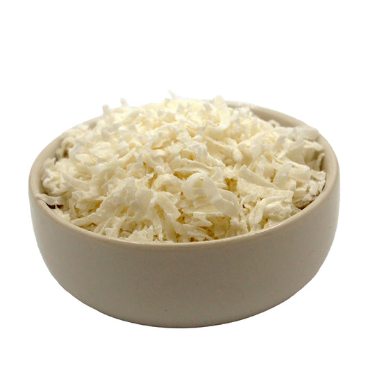 Bowl filled with sweetened coconut flakes for baking and dessert recipes