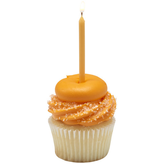 Vanilla cupcake with orange frosting swirls and sparkling sugar crystals, topped with a single slim tan birthday candle lit with a small flame.