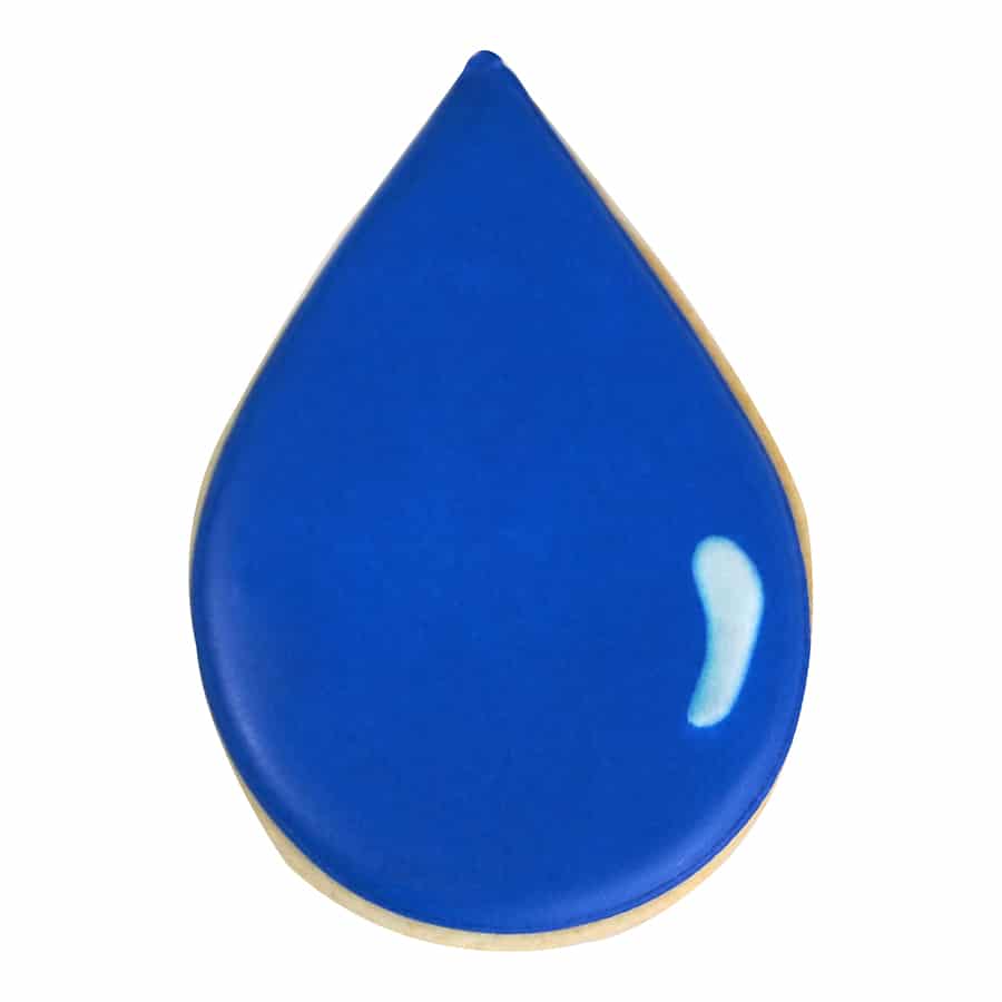 Teardrop-shaped sugar cookie with a smooth blue royal icing finish, resembling a raindrop with a white highlight for added dimension.