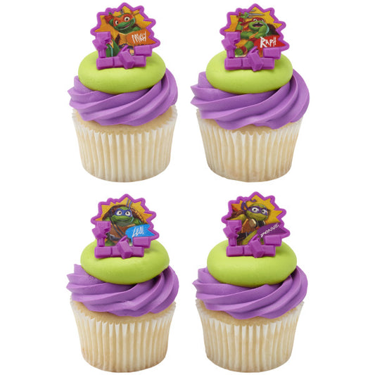 Vanilla cupcakes topped with purple and green frosting, each decorated with a Teenage Mutant Ninja Turtles character ring