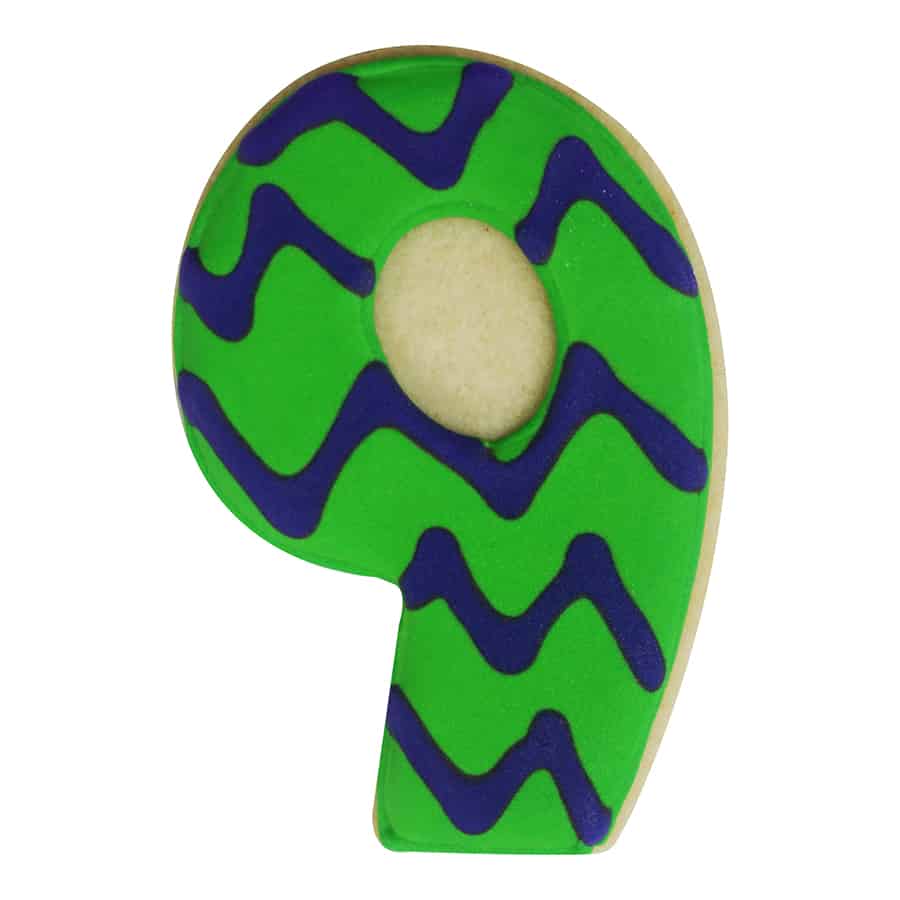 Decorated number 9 cookie with bright green icing and wavy blue designs, creating a fun, playful look.