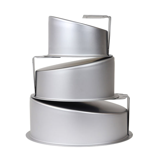 Set of three stacked topsy turvy cake pans in graduated sizes with angled walls and built-in metal supports for level baking.