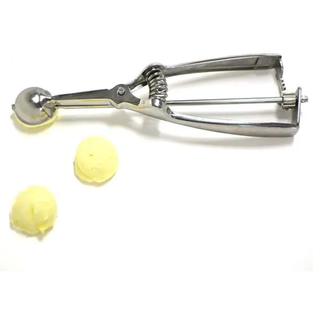 Truffle scoop shown with two uniform scoops of dough or filling on a white surface, demonstrating its size and portioning accuracy.