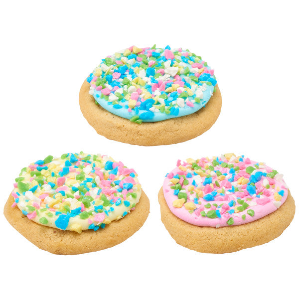 Sugar cookies topped with pastel frosting and sprinkled with tutti frutti flavored candy shards for decoration.