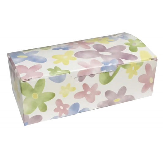 The image displays a rectangular candy box with a watercolor daisy design. The box has a soft pastel background with a pattern of simple, stylized daisies in light pink, blue, yellow, and green hues, giving it a gentle, springtime feel.