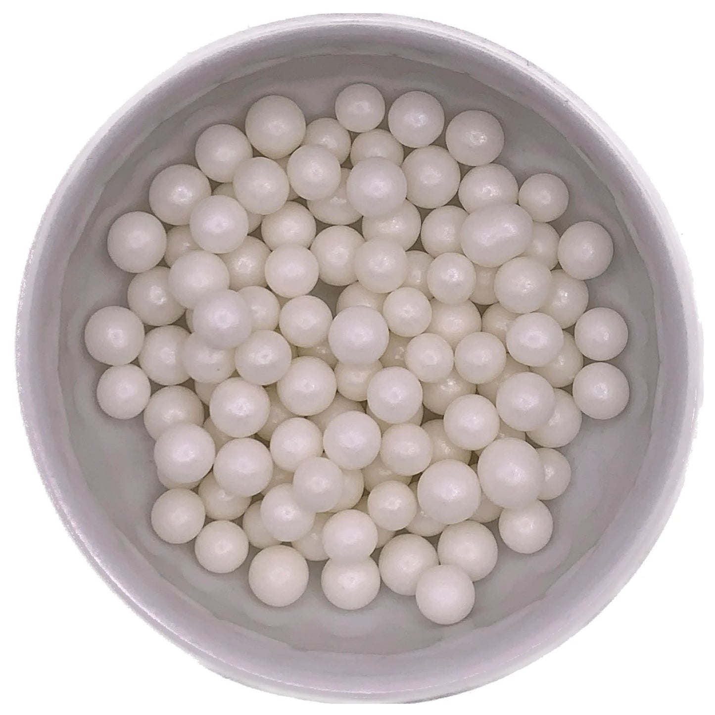 Close-up of edible white pearlized dragees, 8mm in size, displayed in a bowl for cake and dessert decoration.