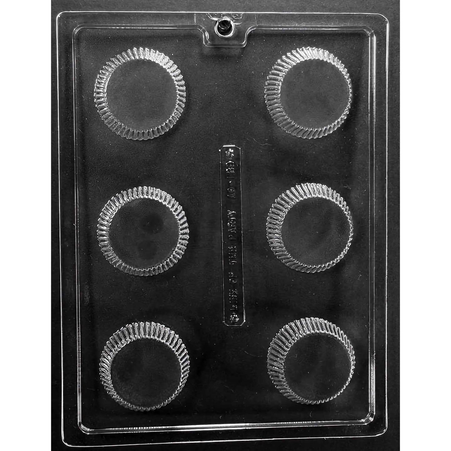 Clear plastic chocolate mold designed for making extra-large peanut butter cups, featuring six round compartments with a distinctive ridged edge, mimicking the classic peanut butter cup design. The mold is displayed against a black background, emphasizing the clarity and details of the compartments.