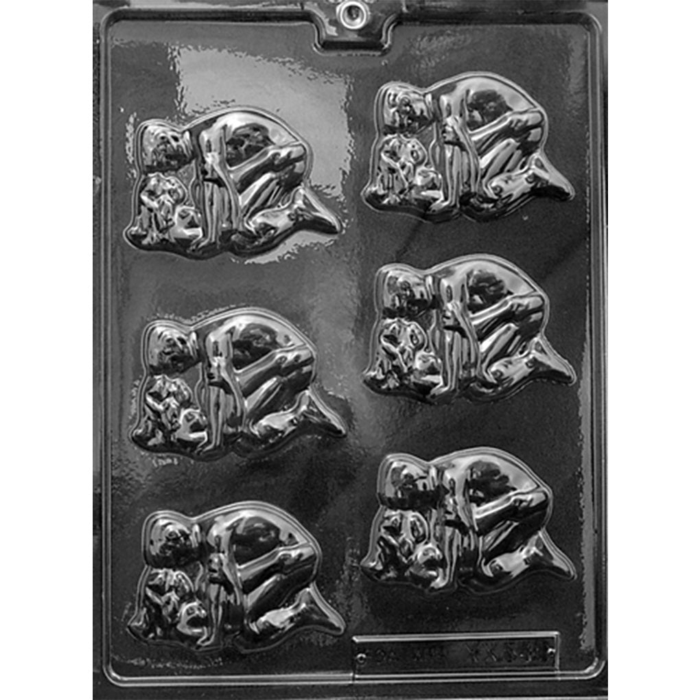 Clear plastic chocolate mold photographed against a black background with six detailed cavities depicting adult couples embracing in an intimate, suggestive pose.