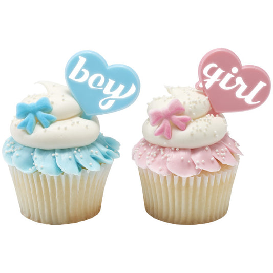 Baby shower cupcakes topped with boy and girl heart toppers and sugar bow decorations in pastel pink and blue.