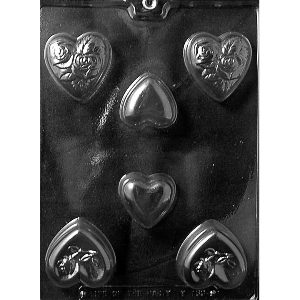 Clear plastic chocolate mold photographed on a black background with assorted heart-shaped cavities in different sizes, including hearts with raised rose details and smooth hearts.