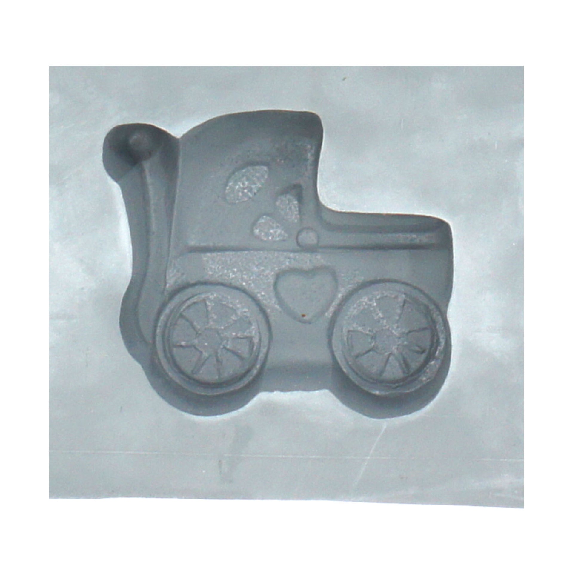 Close-up of a baby buggy-shaped cavity in a natural rubber mint mold, perfect for making themed cream cheese mints or chocolates for baby showers.