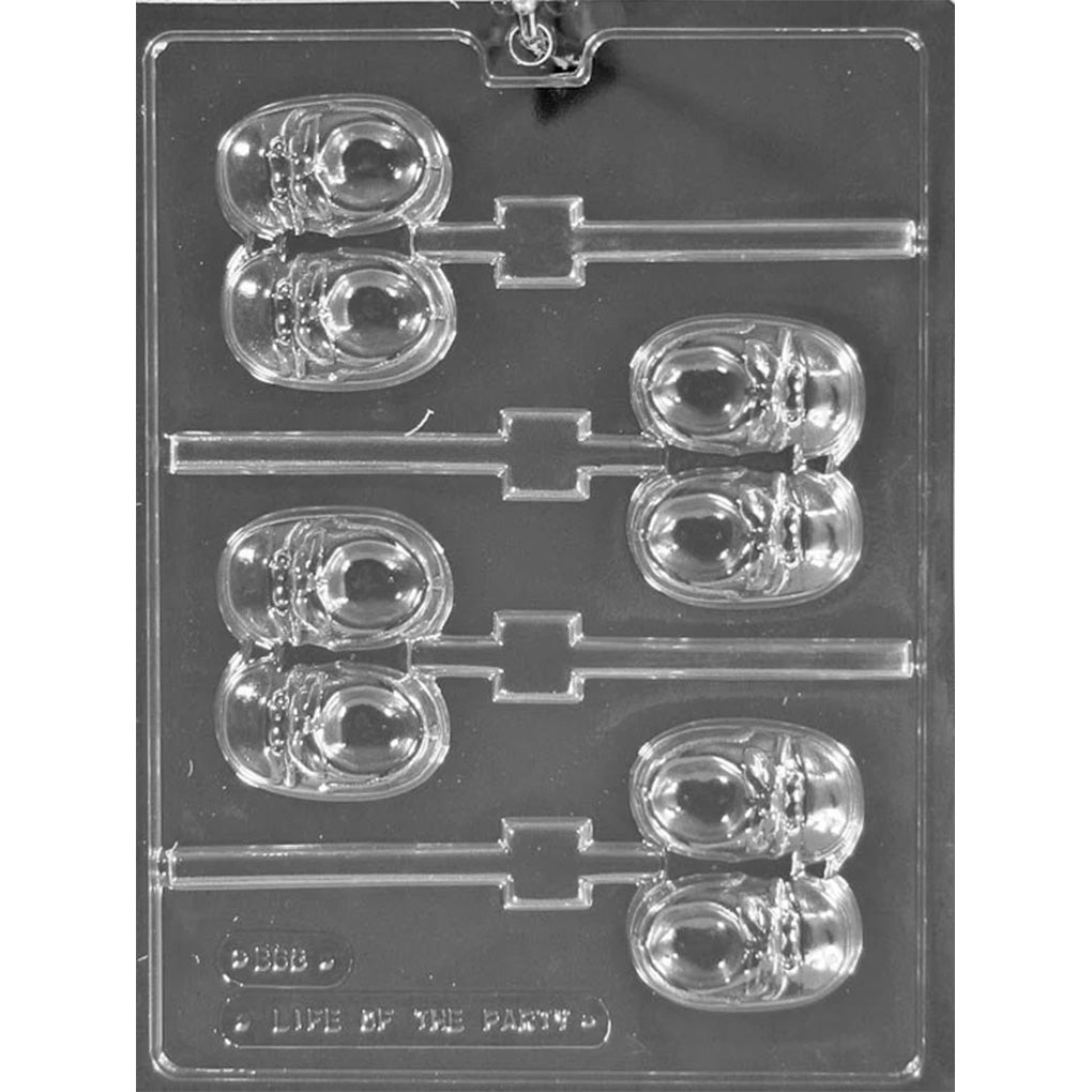 Clear plastic chocolate lollipop mold with four baby shoe cavities featuring raised laces and soles, plus stick channels for making baby shoe chocolate pops.