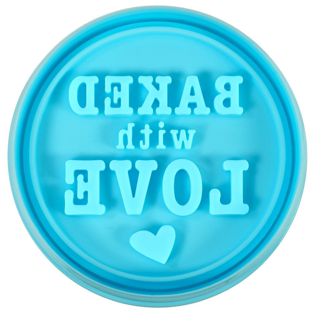 Close-up of the "Baked with Love" cookie stamp, showing the reversed embossed lettering.