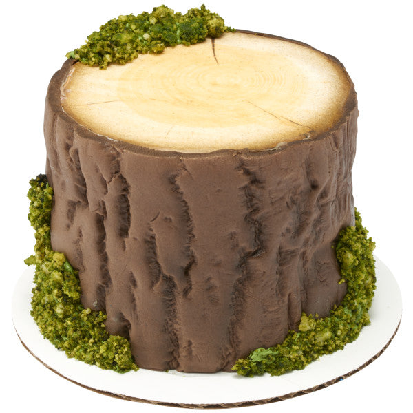 Cake decorated like a tree stump with realistic bark texture and moss accents