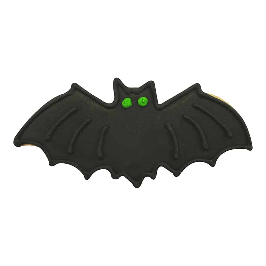Decorated bat-shaped cookie with black icing and green eyes, perfect for Halloween treats.