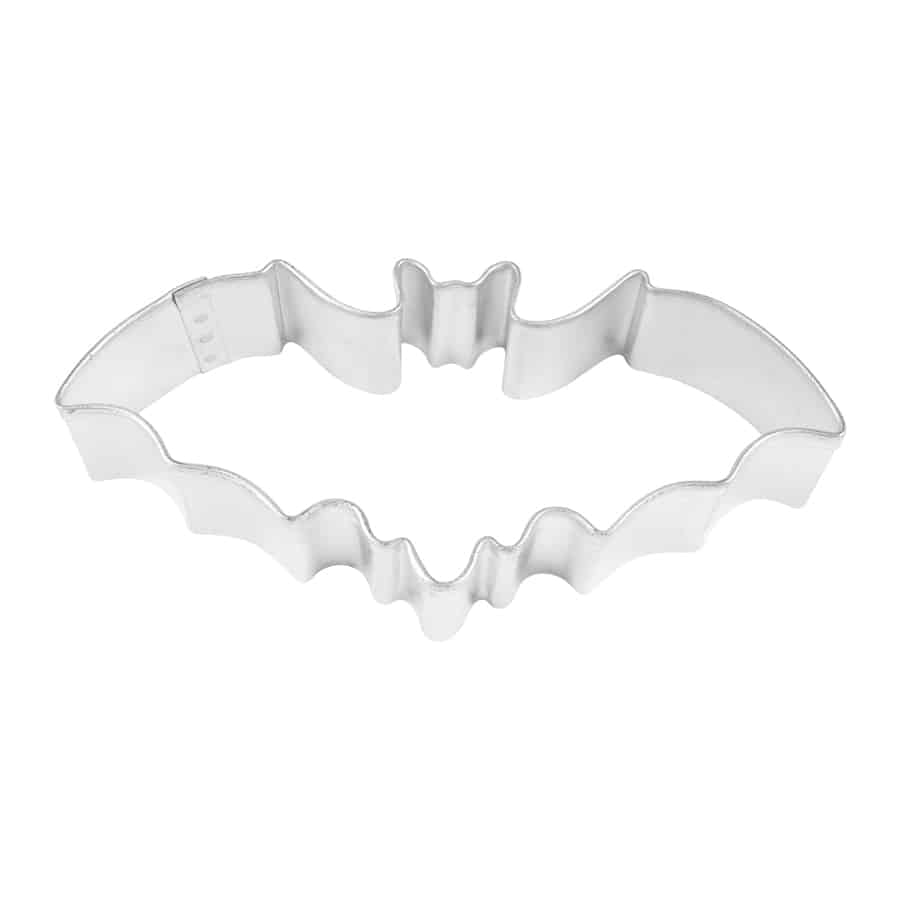Overhead view of a metal bat-shaped cookie cutter with outstretched wings.