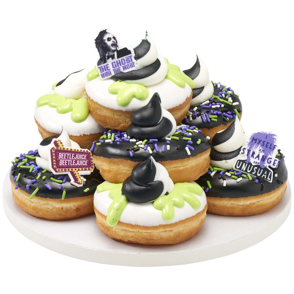 Beetlejuice, Lydia, and Beetlejuice sign rings decorating Halloween donuts with black-and-white frosting, green icing, and purple sprinkles