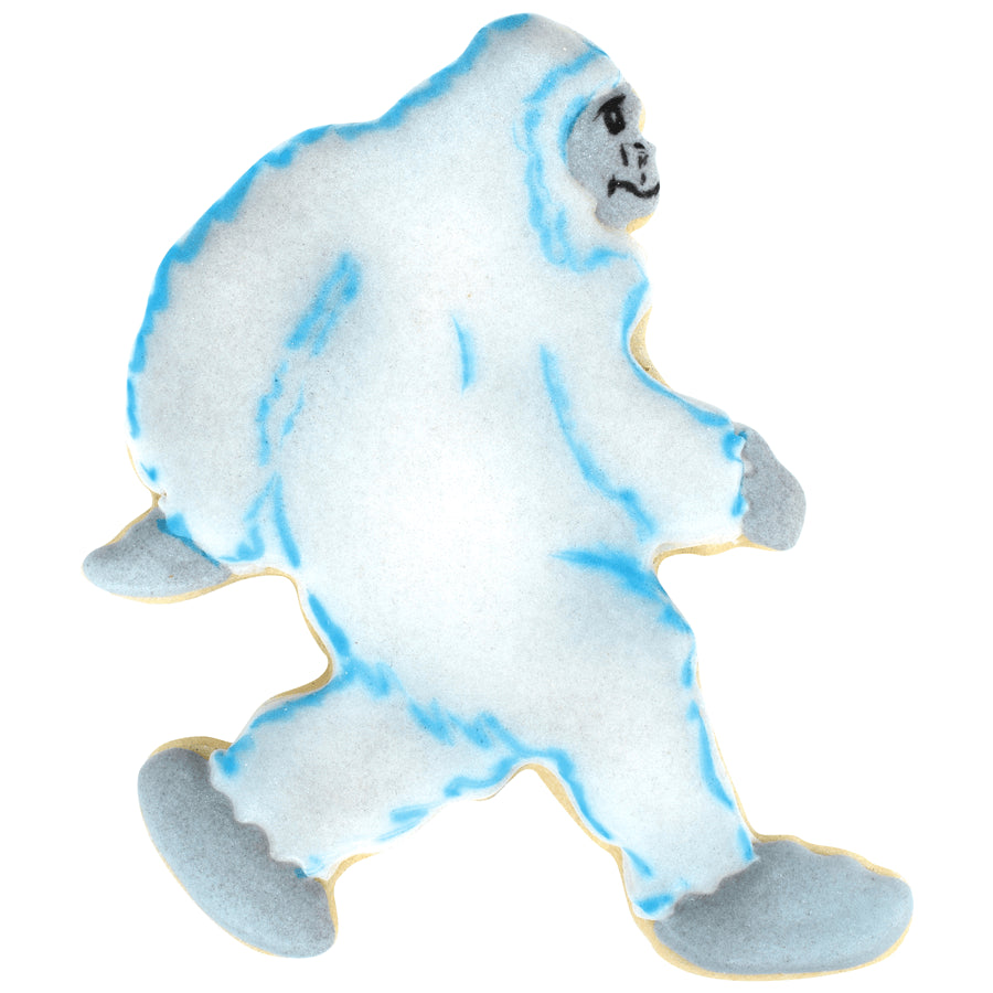 Decorated Yeti cookie with white and blue icing, featuring frosty fur accents.
