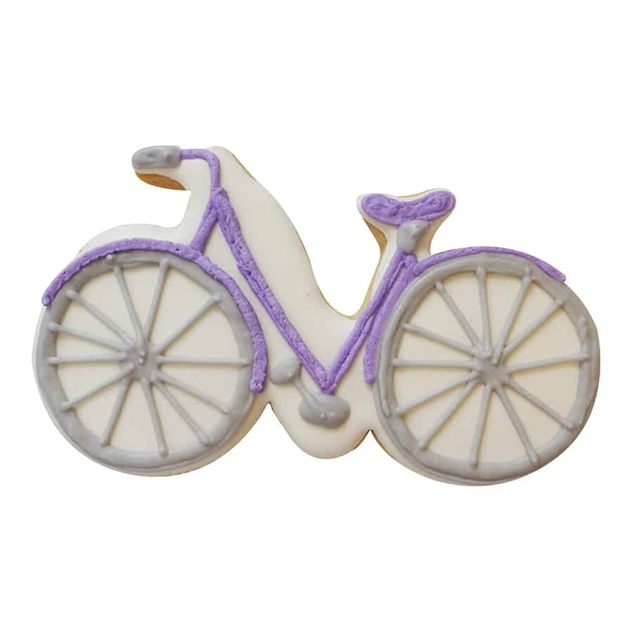 A decorated bicycle-shaped cookie with white icing and purple handlebars, seat, and accents.