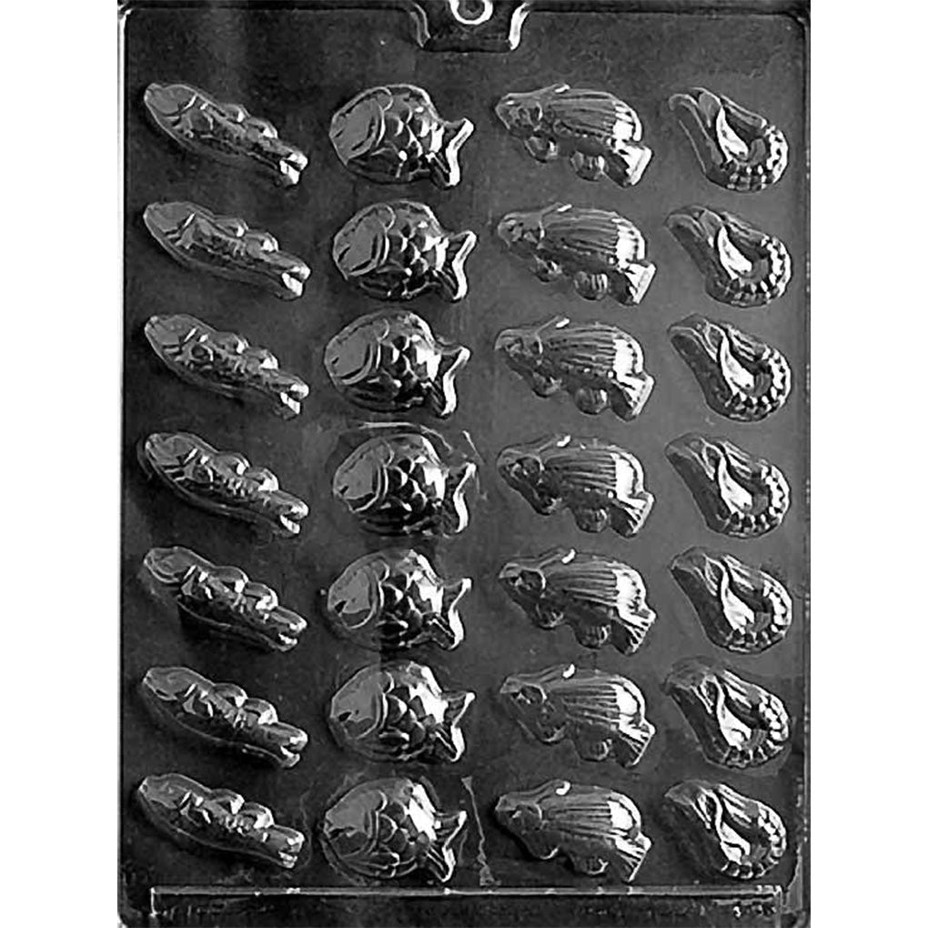 Clear plastic chocolate mold tray photographed on a black background, featuring multiple small fish-shaped cavities in rows with raised fin and scale details.