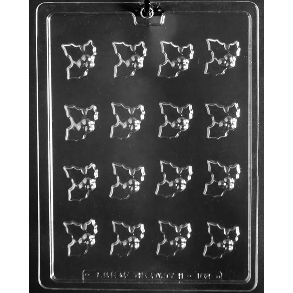 Clear plastic chocolate mold tray with sixteen small holly leaf cavities, each with a raised berry cluster.