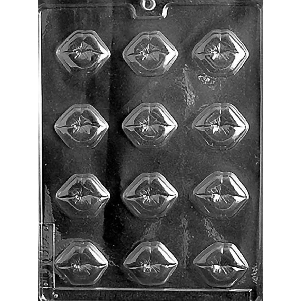 Clear chocolate mold with 12 small faceted lip-shaped cavities arranged in four rows against a dark background, each with defined upper and lower lips.