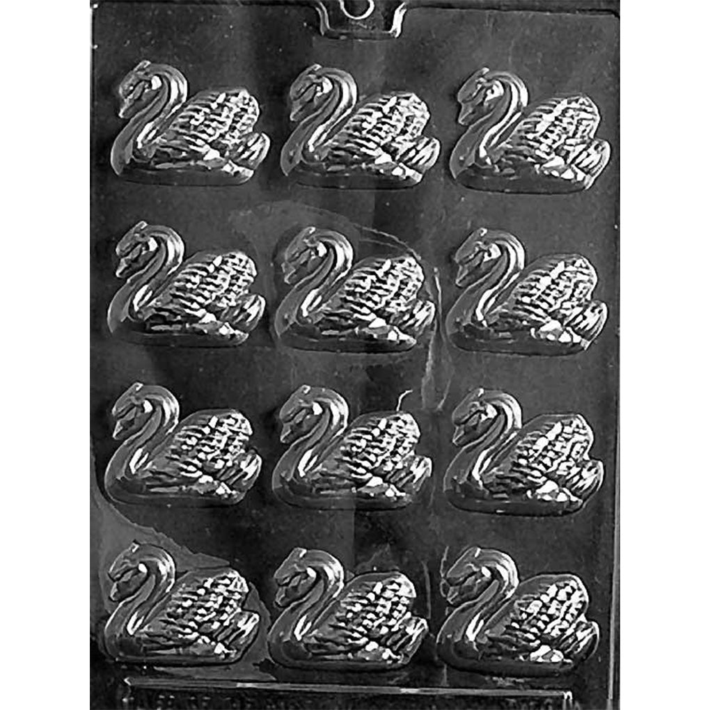 Clear plastic chocolate mold photographed on a black background with rows of small swan-shaped cavities, showing curved necks and textured feather wings.