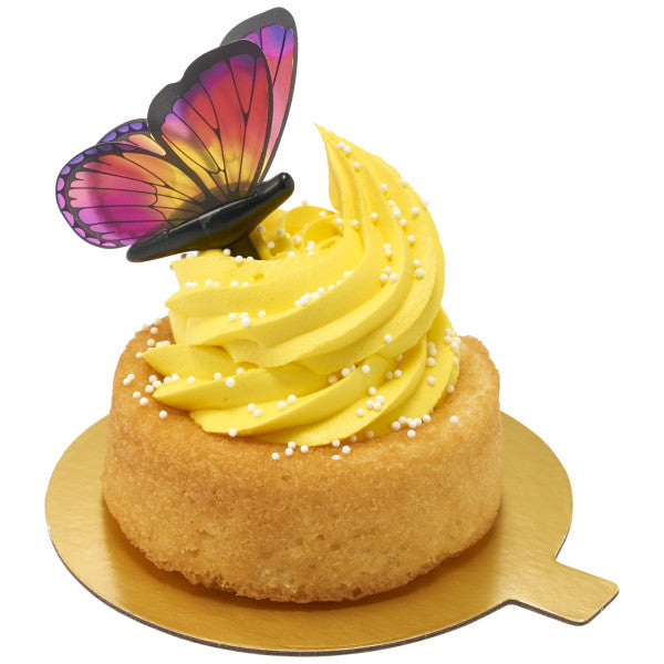 Yellow butterfly cupcake displayed on a gold board