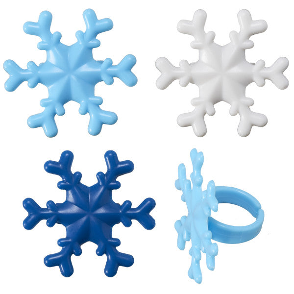 Close-up of blue and white plastic snowflake cupcake rings in assorted colors with a side view showing the attached ring.